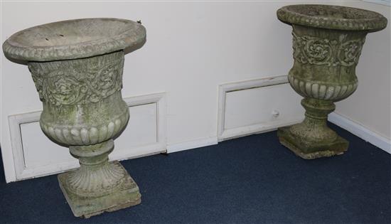 A pair of reconstituted stone fluted garden urns, H.75cm